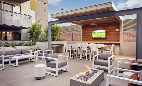 outdoor lounge with firepits and TV