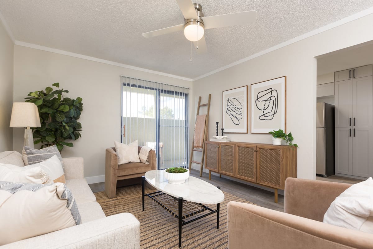 Furnished apartment living area shown — representative home at Reveal.
