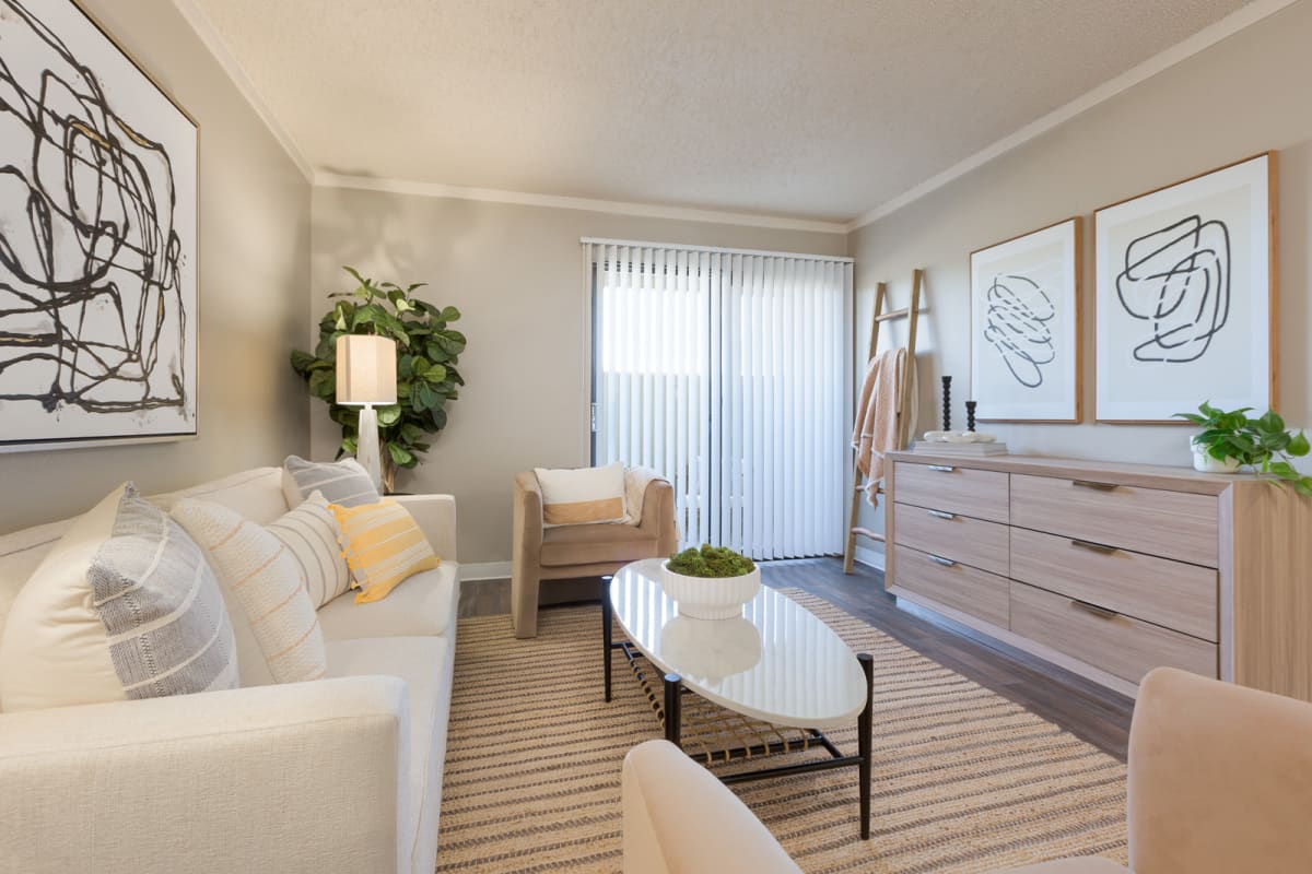 Furnished apartment living area shown — representative home at Reveal.