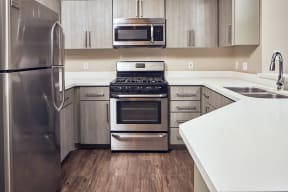 Apartments for Rent in Escondido, CA - Alta Vista Kitchen with stainless steel appliances, and modern wood cabinets