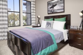 Apartments for Rent in Mission Valley - Spacious Bedroom with Two Windows, Plush Carpet, and Modern Furnishings.