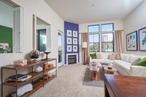 Luxury Apartments for Rent in Mission Valley - Open Concept Living Room with Plush Carpet, Two Windows, and Fireplace.