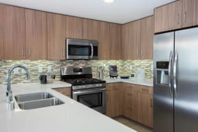 Kitchen With Brown Cabinets, Stainless-Steel Appliances, And Quartz Countertops at Nineteen800, California, 95014