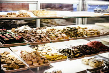 a display case in a bakery filled with pastries