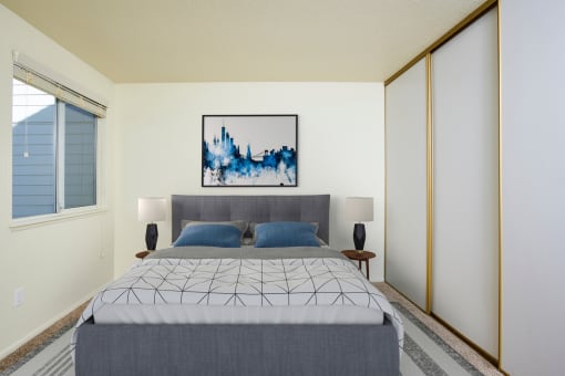 a bedroom with white walls and a large bed with blue pillows