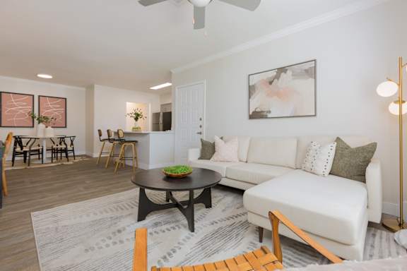 A living room with a white couch and a coffee table.