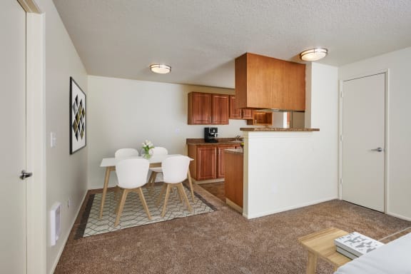 Dining area with a table and chairs and a kitchen in the background at Brookside 112, Vancouver, WA, 98682