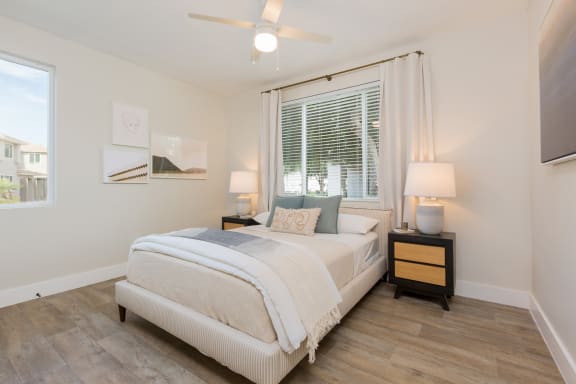 a bedroom with a bed and a ceiling fan