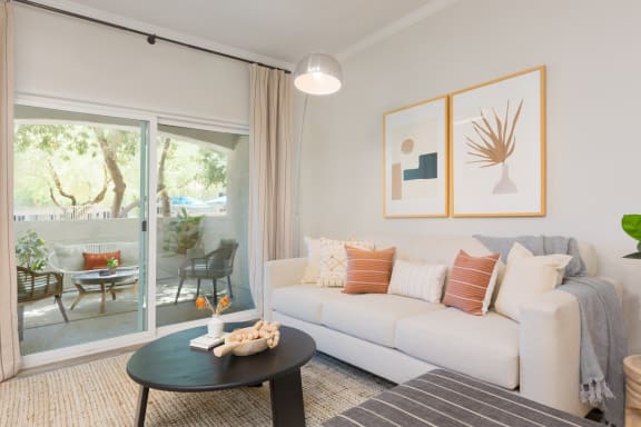 a living room with a white couch and a black coffee table