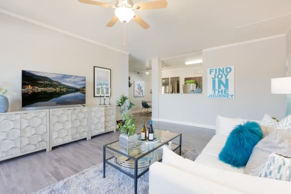 a living room with a white couch and a glass coffee table