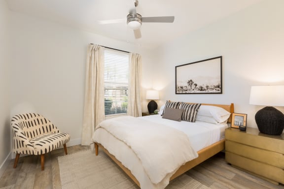 a bedroom with a bed and a chair
