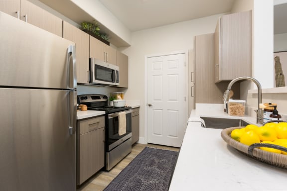 a kitchen with stainless steel appliances and a white counter top