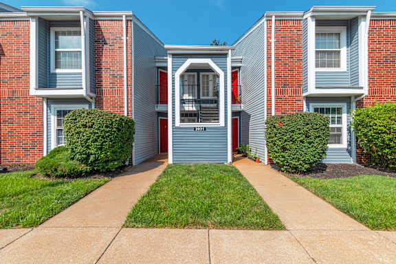 A red brick house with a blue garage door.