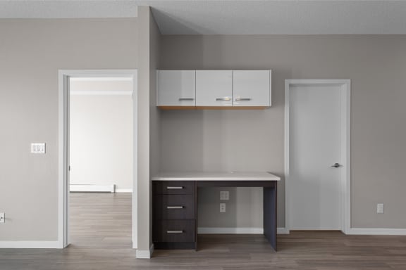 an empty room with a desk and a closet