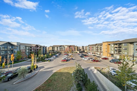 an aerial view of an apartment complex with a parking lot