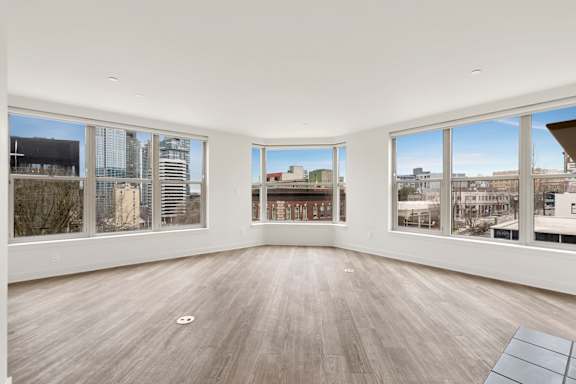 Large empty room with Wooden floor at AVIA on Pike Street, Seattle, Washington