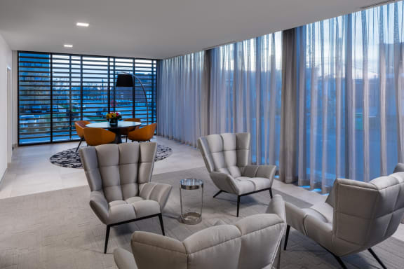 a living room filled with furniture and a large window