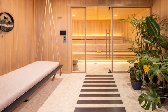 a room with a hammock and a sauna