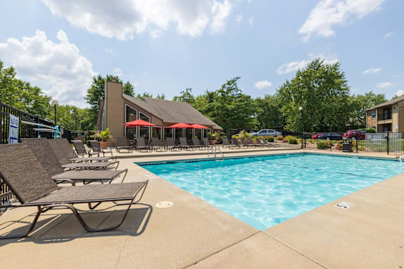 A sparkling pool with lounge chairs and umbrellas for a relaxing afternoon.