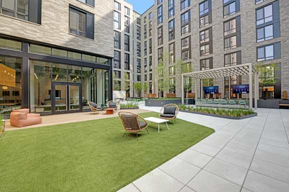 A modern building with a green lawn in front.