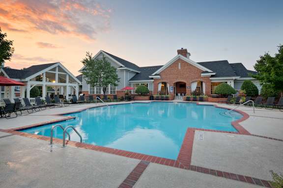 A large swimming pool surrounded by a brick border.