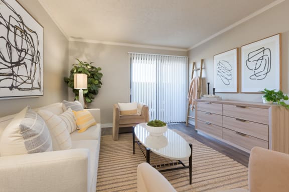 a living room with a couch coffee table and a dresser