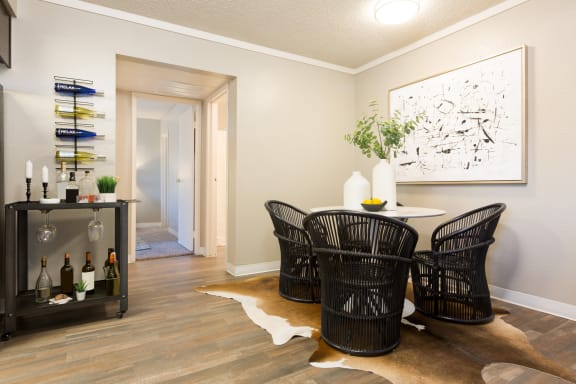 a dining room with a table and four chairs