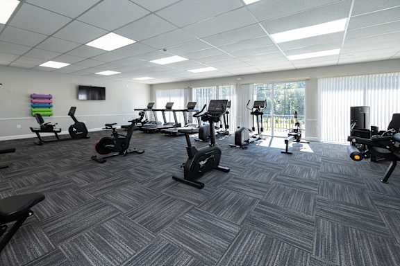 A gym with a variety of exercise equipment.