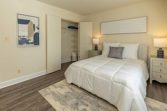 A room with a rug and a table with a white door and a window. at The Brittany Apartments, Pikesville, Maryland