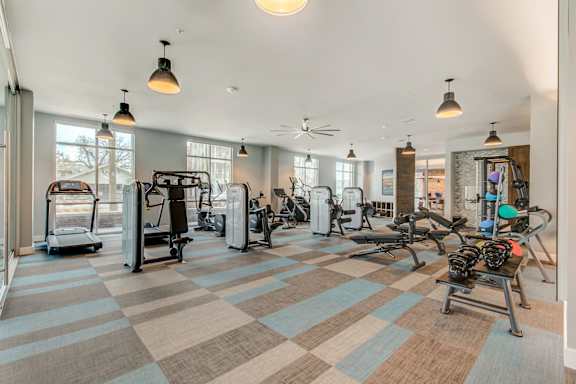 A gym with a variety of exercise equipment.