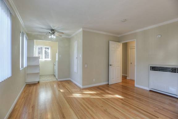 a room with a door open to a bathroom and a closet