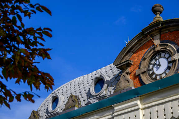 A clock tower with a blue sky in the background.