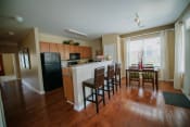 Thumbnail 1 of 11 - Kitchen, energy star black appliances, hardwood floors, pantry, dining room table, kitchen island with three barstools