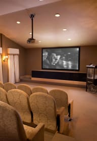 a large screening room with chairs and a projector screen at Versailles on the Lakes Oakbrook*, Oakbrook Terrace, 60181