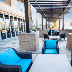 an outdoor lounge area with blue couches and chairs