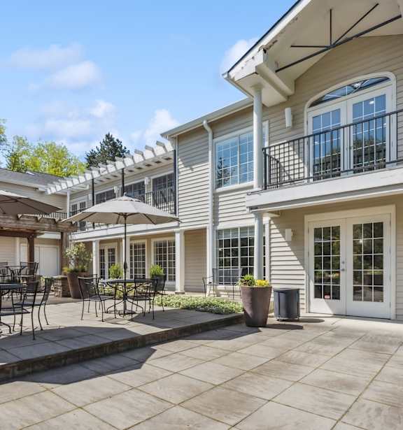 a patio with tables and umbrellas and a fire pit at Murrayhill Park, Oregon, 97008
