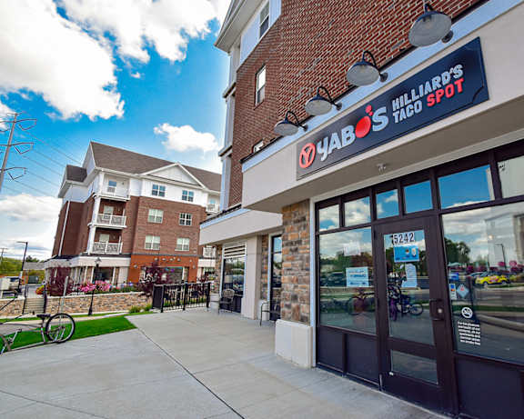 a woman walking down a sidewalk in front of a grocery store