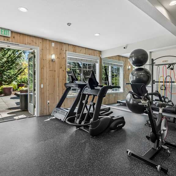 an empty living room with large windows and carpetingat Murrayhill Park, Beaverton, OR