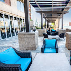 an outdoor lounge area with blue couches and chairs