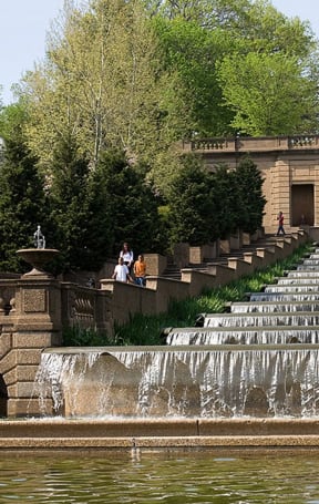 A large waterfall with people sitting on the steps in front of it at Diplomat Washington DC 20009