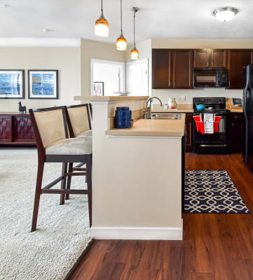 Hardwood floor kitchen with eat in island at Kenyon Square Apartments, Westerville, 43082