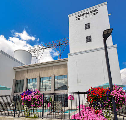 a white building with pink and purple flowers in front of it
