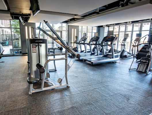 a gym with treadmills and other exercise equipment