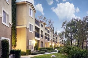 Escondido, CA Apartments - Exterior View of Alta Vista Apartments Building Surrounded By Lush Landscaping