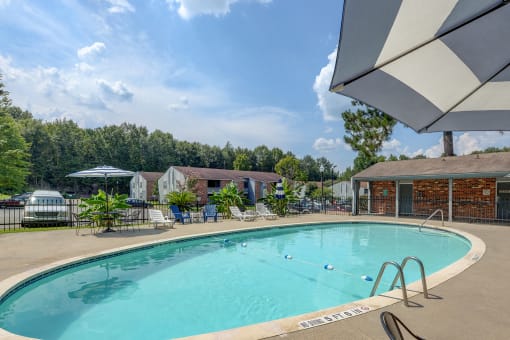 Pool with lounge chairs at Landmark Apartment Homes, Mississippi