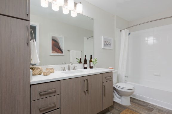 a bathroom with a toilet sink and bathtub in a 555 waverly unit