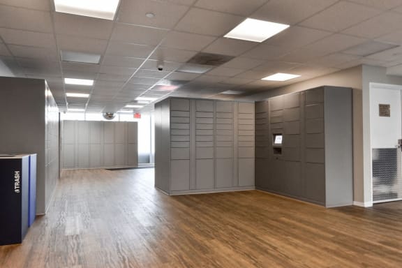 a large room with wooden floors and grey lockers