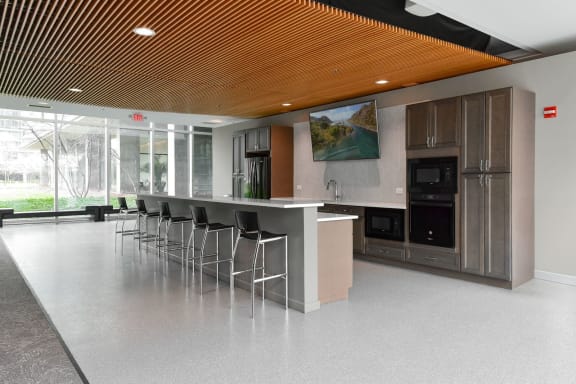 the kitchen has a large island with stools and a large