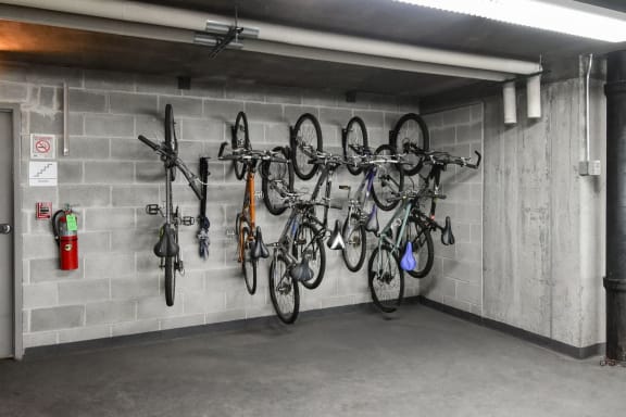 a parking garage with bikes hanging on the wall