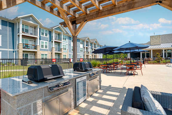Grilling area under gazebo next to the pool